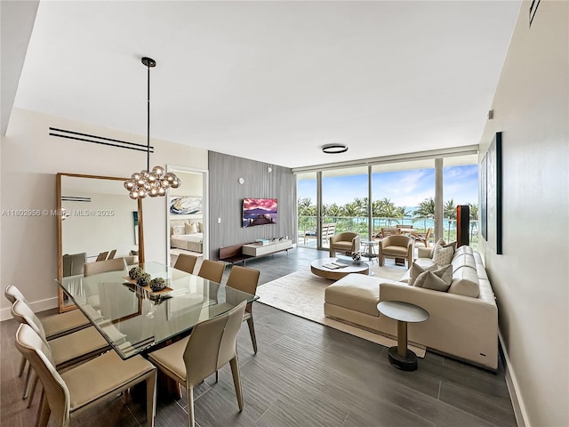 10203 Collins Ave Unit 302, Bal Harbour, FL 33154 - dining space featuring baseboards, wood finished floors, floor to ceiling windows, and a chandelier