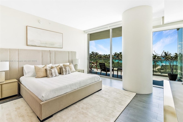 10203 Collins Ave Unit 302, Bal Harbour, FL 33154 - bedroom with multiple windows, access to outside, light wood finished floors, and a wall of windows
