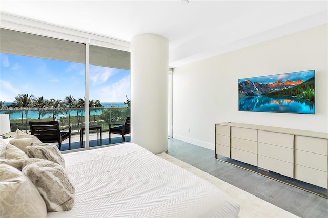 10203 Collins Ave Unit 302, Bal Harbour, FL 33154 - bedroom with wood finished floors, expansive windows, and baseboards