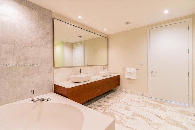 10203 Collins Ave Unit 302, Bal Harbour, FL 33154 - bathroom featuring double vanity, a bath, recessed lighting, and marble finish floors