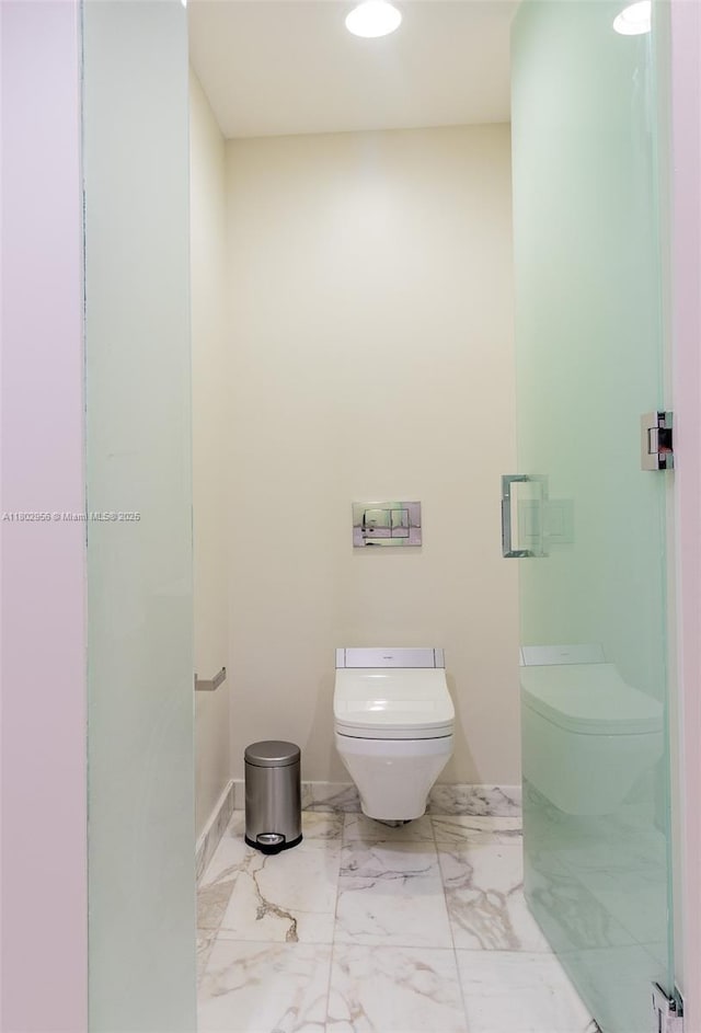 10203 Collins Ave Unit 302, Bal Harbour, FL 33154 - bathroom featuring toilet and marble finish floors