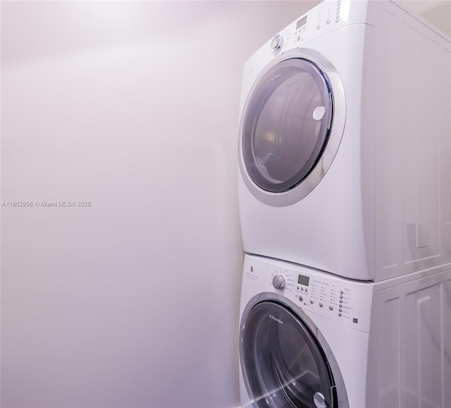 10203 Collins Ave Unit 302, Bal Harbour, FL 33154 - laundry room with stacked washer / drying machine