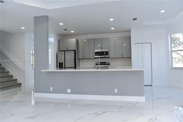 2925 SW 133rd Ave, Miramar, FL 33027 - kitchen with stainless steel appliances, gray cabinetry, baseboards, modern cabinets, and recessed lighting