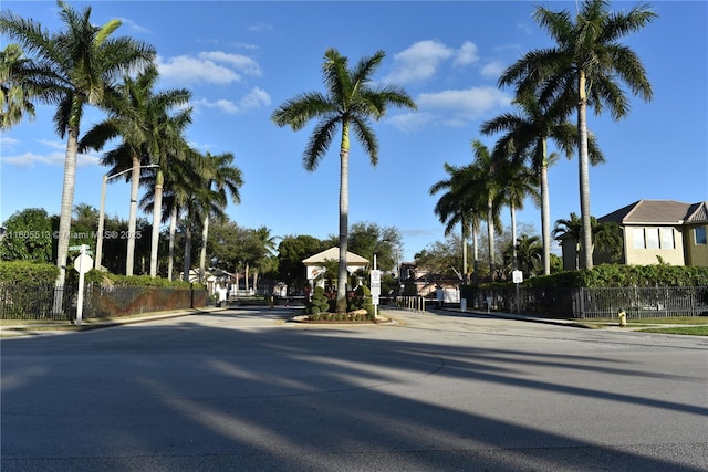 2925 SW 133rd Ave, Miramar, FL 33027 - view of asphalt road with traffic signs, curbs, sidewalks, and a gated entry