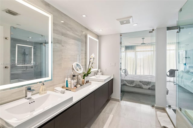 1201 20th St Unit 314, Miami Beach, FL 33139 - ensuite bathroom featuring a shower stall, tile walls, a ceiling fan, baseboards, and double vanity