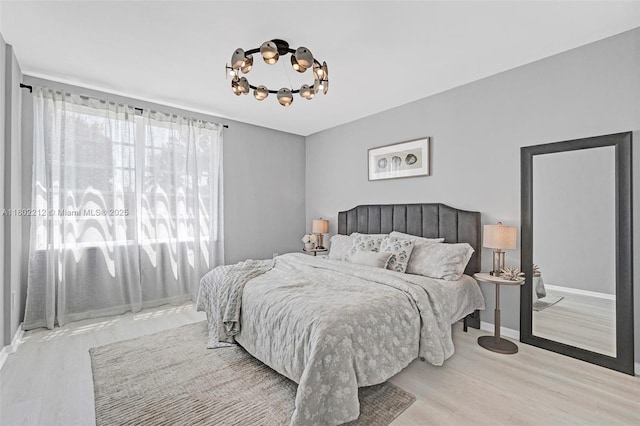 1150 Euclid Ave Unit 305, Miami Beach, FL 33139 - bedroom with a chandelier and wood finished floors