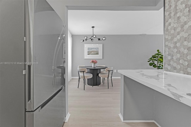 1150 Euclid Ave Unit 305, Miami Beach, FL 33139 - dining room featuring light wood-type flooring and a chandelier