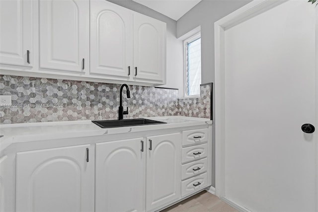 1150 Euclid Ave Unit 305, Miami Beach, FL 33139 - kitchen featuring white cabinetry, light countertops, and decorative backsplash