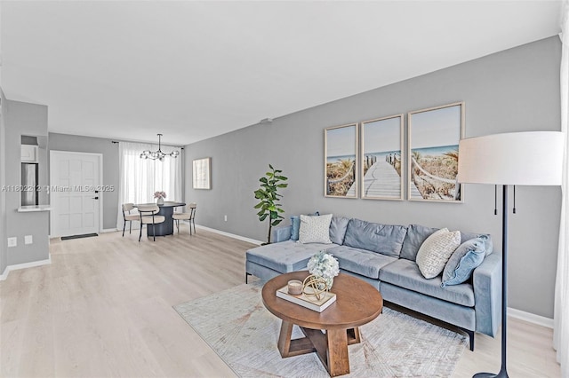 1150 Euclid Ave Unit 305, Miami Beach, FL 33139 - living room featuring wood finished floors and a chandelier