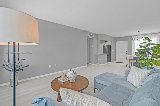 1150 Euclid Ave Unit 305, Miami Beach, FL 33139 - bedroom with a chandelier and wood finished floors