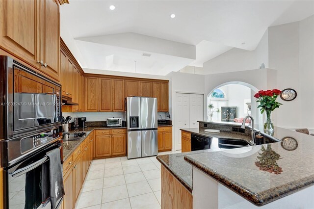 5957 NW 125th Ave, Coral Springs, FL 33076 - kitchen with black appliances, a sink, vaulted ceiling, light tile patterned flooring, and arched walkways