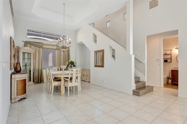 5957 NW 125th Ave, Coral Springs, FL 33076 - dining area featuring a towering ceiling, stairway, a chandelier, light tile patterned floors, and healthy amount of natural light