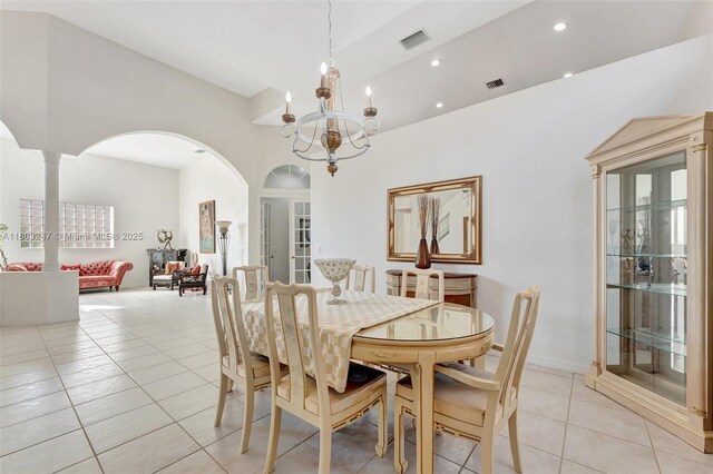 5957 NW 125th Ave, Coral Springs, FL 33076 - dining space featuring arched walkways, light tile patterned floors, a chandelier, a high ceiling, and recessed lighting