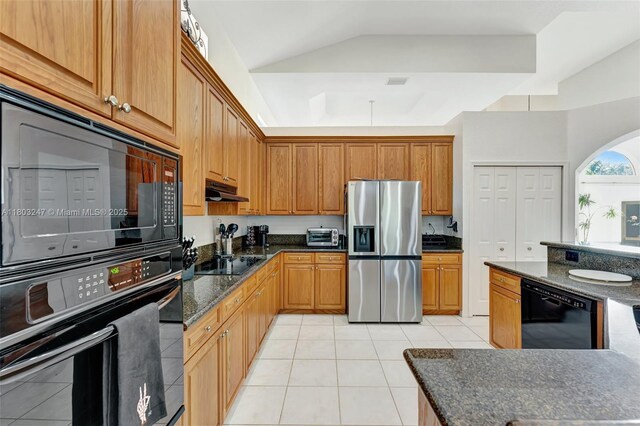 5957 NW 125th Ave, Coral Springs, FL 33076 - kitchen featuring black appliances, light tile patterned floors, dark stone countertops, lofted ceiling, and under cabinet range hood
