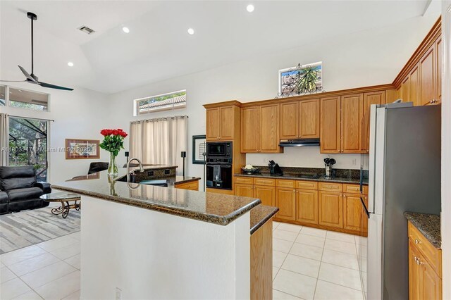 5957 NW 125th Ave, Coral Springs, FL 33076 - kitchen with black appliances, high vaulted ceiling, light tile patterned floors, a ceiling fan, and a sink