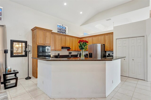5957 NW 125th Ave, Coral Springs, FL 33076 - kitchen with black appliances, light tile patterned floors, high vaulted ceiling, an island with sink, and under cabinet range hood