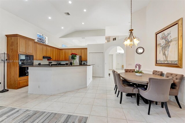 5957 NW 125th Ave, Coral Springs, FL 33076 - kitchen with black appliances, dark countertops, arched walkways, high vaulted ceiling, and light tile patterned floors