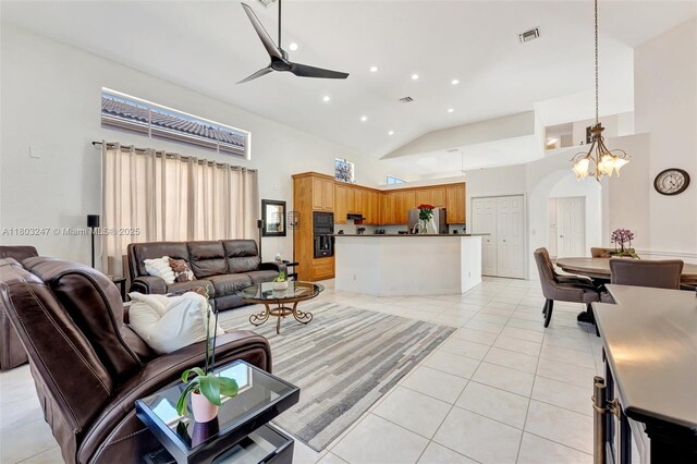 5957 NW 125th Ave, Coral Springs, FL 33076 - living area featuring light tile patterned floors, high vaulted ceiling, a ceiling fan, arched walkways, and a chandelier