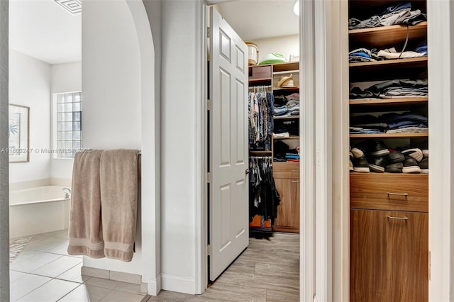 5957 NW 125th Ave, Coral Springs, FL 33076 - spacious closet featuring arched walkways and light tile patterned floors