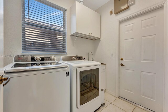 5957 NW 125th Ave, Coral Springs, FL 33076 - laundry area featuring washer and dryer, cabinet space, and light tile patterned floors