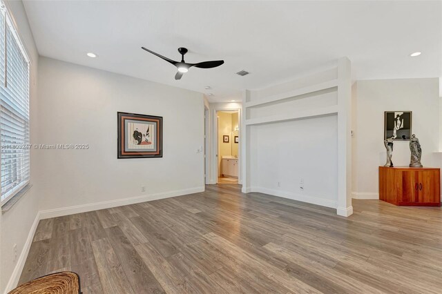5957 NW 125th Ave, Coral Springs, FL 33076 - empty room featuring ceiling fan, wood finished floors, healthy amount of natural light, and recessed lighting