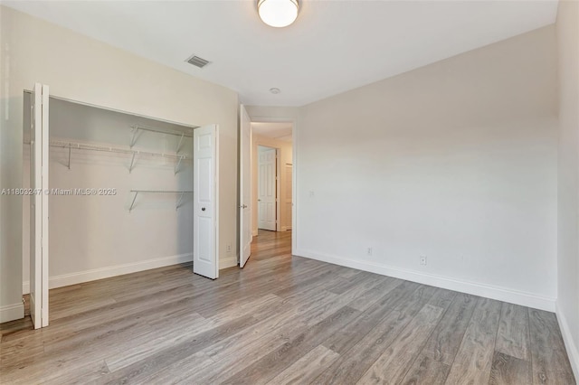 5957 NW 125th Ave, Coral Springs, FL 33076 - unfurnished bedroom with wood finished floors, baseboards, and a closet