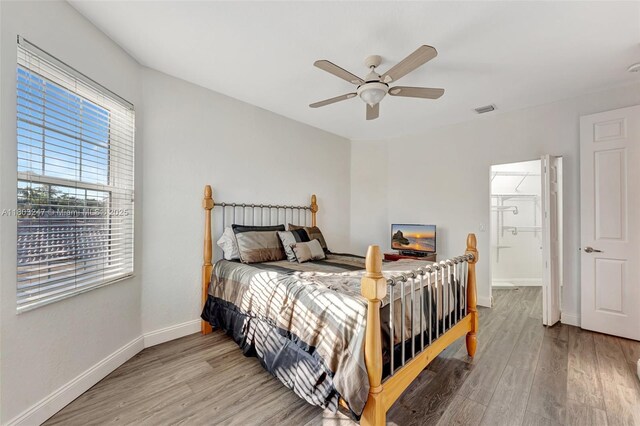 5957 NW 125th Ave, Coral Springs, FL 33076 - bedroom with wood finished floors, baseboards, and ceiling fan
