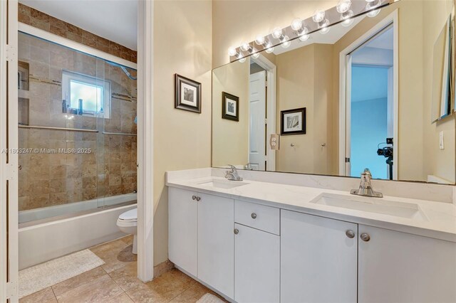 5957 NW 125th Ave, Coral Springs, FL 33076 - bathroom with toilet, double vanity, enclosed tub / shower combo, and tile patterned floors