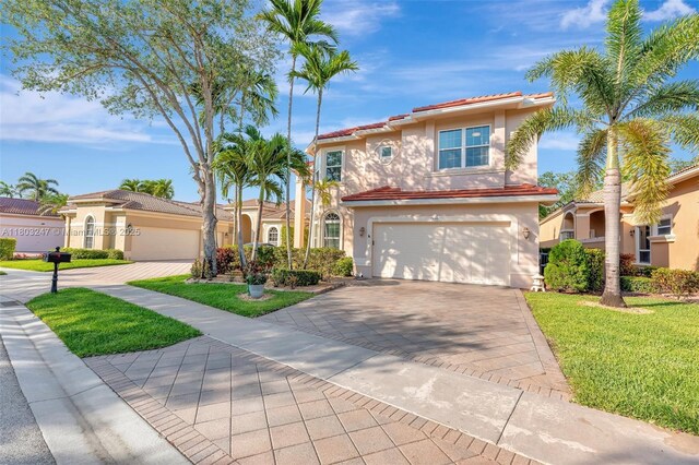 5957 NW 125th Ave, Coral Springs, FL 33076 - mediterranean / spanish-style home with stucco siding, driveway, an attached garage, a front yard, and a tiled roof