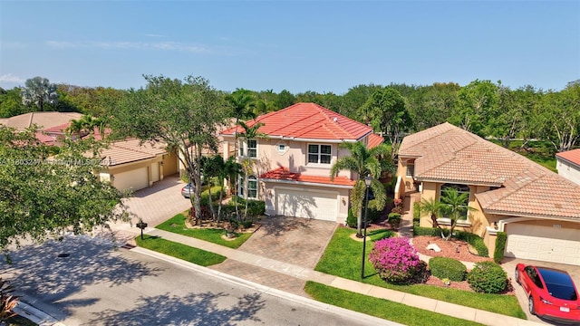 5957 NW 125th Ave, Coral Springs, FL 33076 - mediterranean / spanish house featuring a tiled roof, stucco siding, and decorative driveway