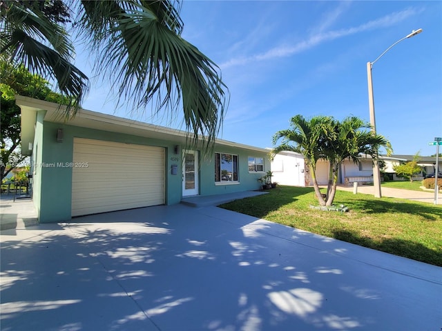 4519 NW 49th Dr, Tamarac, FL 33319 - single story home featuring driveway, a garage, stucco siding, and a front yard