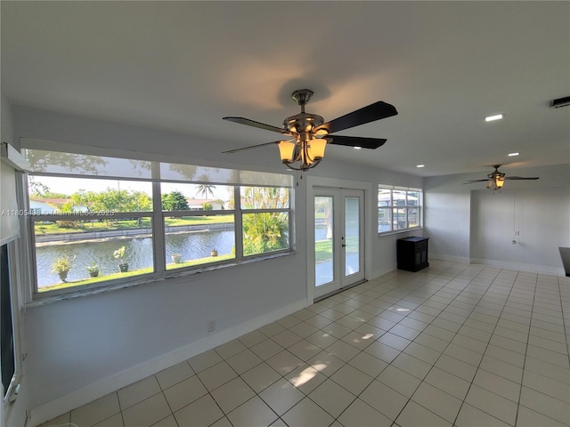 4519 NW 49th Dr, Tamarac, FL 33319 - unfurnished living room featuring ceiling fan, light tile patterned floors, a water view, baseboards, and french doors