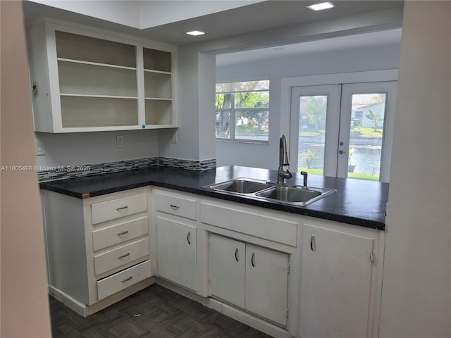 4519 NW 49th Dr, Tamarac, FL 33319 - kitchen featuring a sink, dark countertops, and white cabinetry