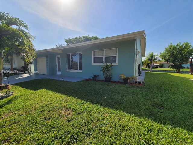 4519 NW 49th Dr, Tamarac, FL 33319 - view of front of property featuring a front lawn, an attached garage, driveway, and stucco siding