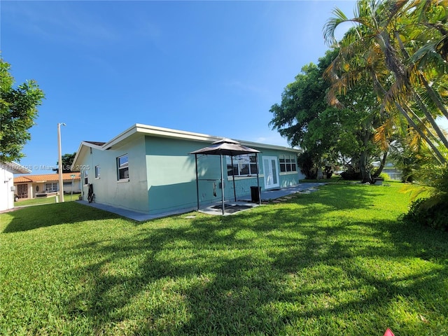 4519 NW 49th Dr, Tamarac, FL 33319 - back of house featuring a yard and stucco siding