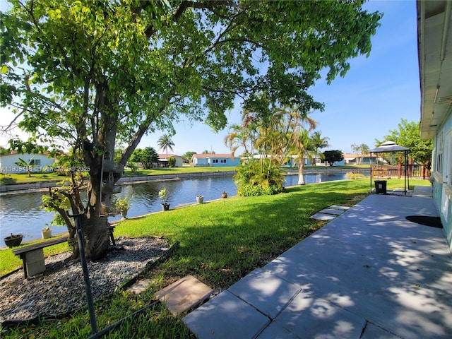 4519 NW 49th Dr, Tamarac, FL 33319 - view of green lawn featuring a water view, a residential view, and a patio