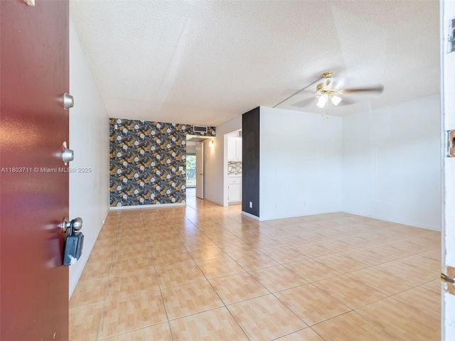 13250 SW 7th Ct Unit 208L, Pembroke Pines, FL 33027 - spare room featuring a ceiling fan, a textured ceiling, and light tile patterned flooring