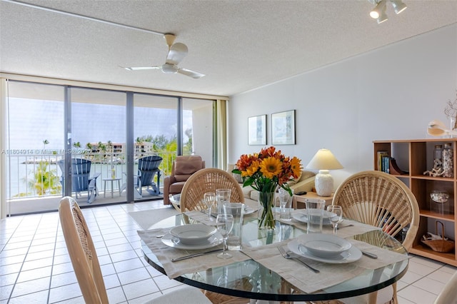 2000 Coco Plum Dr Unit 301, Marathon, FL 33050 - dining space featuring light tile patterned floors, a textured ceiling, expansive windows, and ceiling fan