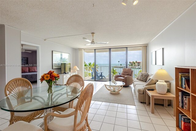 2000 Coco Plum Dr Unit 301, Marathon, FL 33050 - dining space featuring light tile patterned floors, ceiling fan, floor to ceiling windows, and a textured ceiling