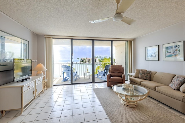 2000 Coco Plum Dr Unit 301, Marathon, FL 33050 - living room with a ceiling fan, floor to ceiling windows, a textured ceiling, and light tile patterned flooring