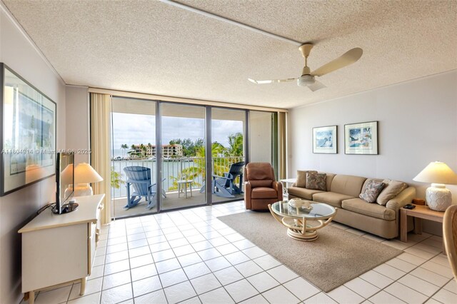 2000 Coco Plum Dr Unit 301, Marathon, FL 33050 - living area featuring a textured ceiling, light tile patterned floors, a ceiling fan, and floor to ceiling windows