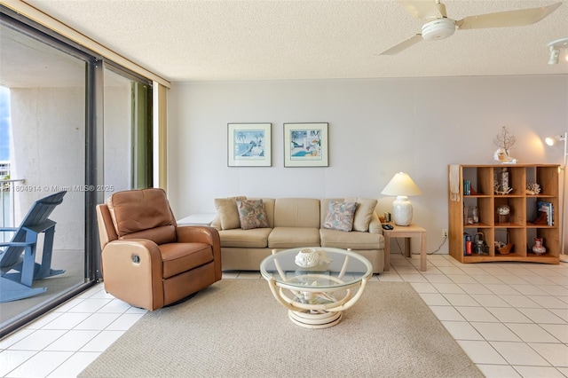 2000 Coco Plum Dr Unit 301, Marathon, FL 33050 - living room featuring light tile patterned flooring, a textured ceiling, a ceiling fan, and plenty of natural light
