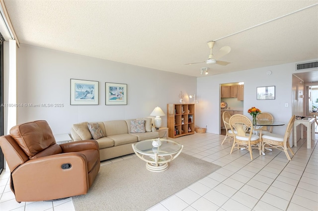 2000 Coco Plum Dr Unit 301, Marathon, FL 33050 - living area featuring light tile patterned floors, ceiling fan, and a textured ceiling