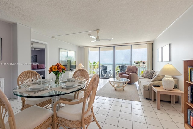 2000 Coco Plum Dr Unit 301, Marathon, FL 33050 - dining space featuring a ceiling fan, light tile patterned flooring, a textured ceiling, and expansive windows