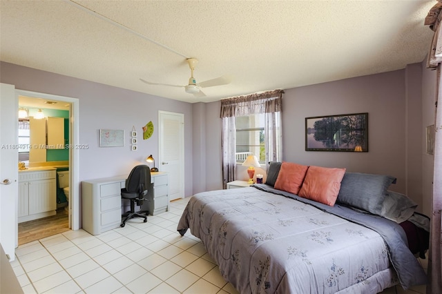 2000 Coco Plum Dr Unit 301, Marathon, FL 33050 - bedroom with an office area, light tile patterned flooring, a textured ceiling, ceiling fan, and ensuite bath