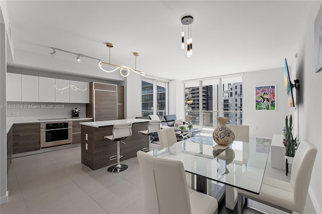 1100 S Miami Ave Unit 3210, Miami, FL 33130 - dining area with light tile patterned floors, track lighting, and expansive windows