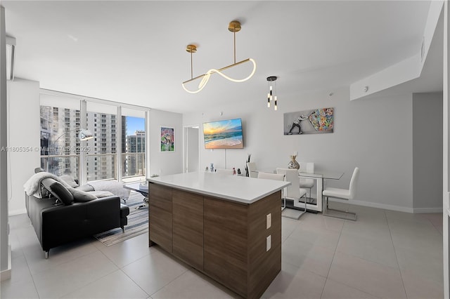1100 S Miami Ave Unit 3210, Miami, FL 33130 - kitchen featuring modern cabinets, a wall of windows, light tile patterned floors, light countertops, and baseboards