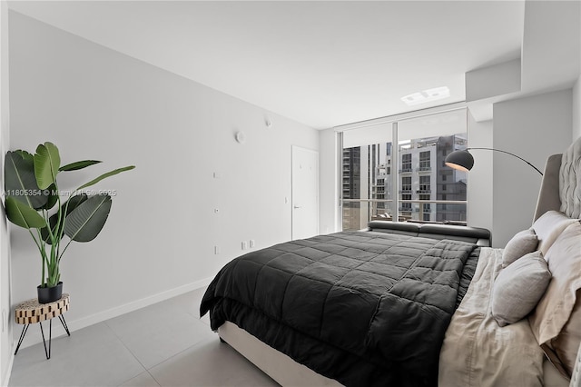 1100 S Miami Ave Unit 3210, Miami, FL 33130 - bedroom with baseboards, a wall of windows, and tile patterned flooring
