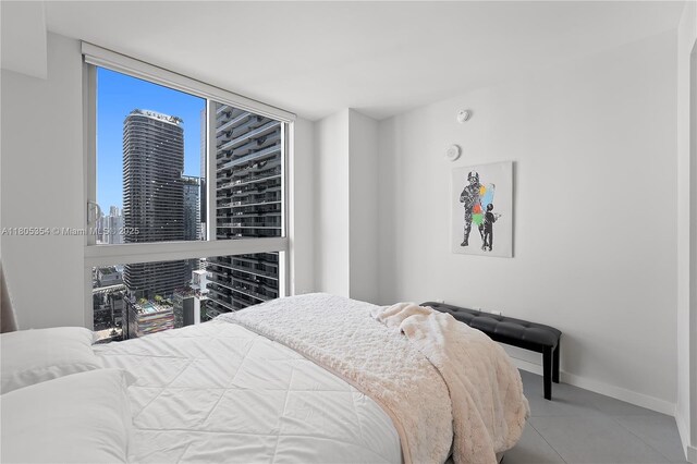 1100 S Miami Ave Unit 3210, Miami, FL 33130 - tiled bedroom featuring a skyline view and baseboards