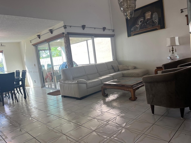 897 NW 97th Ave, Plantation, FL 33324 - living room featuring a textured ceiling and a chandelier